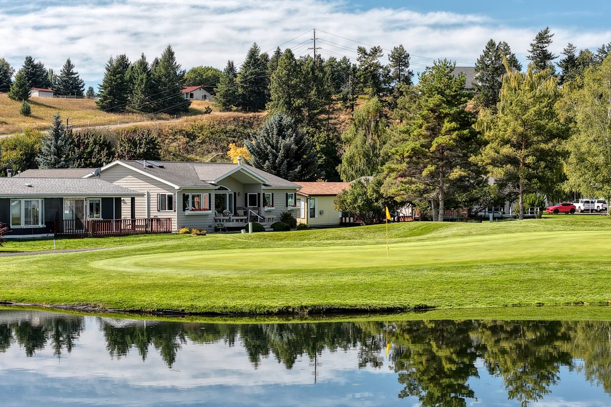 124 W Nicklaus Ave seen from across the pond at Village Greens in Kalispell, Montana