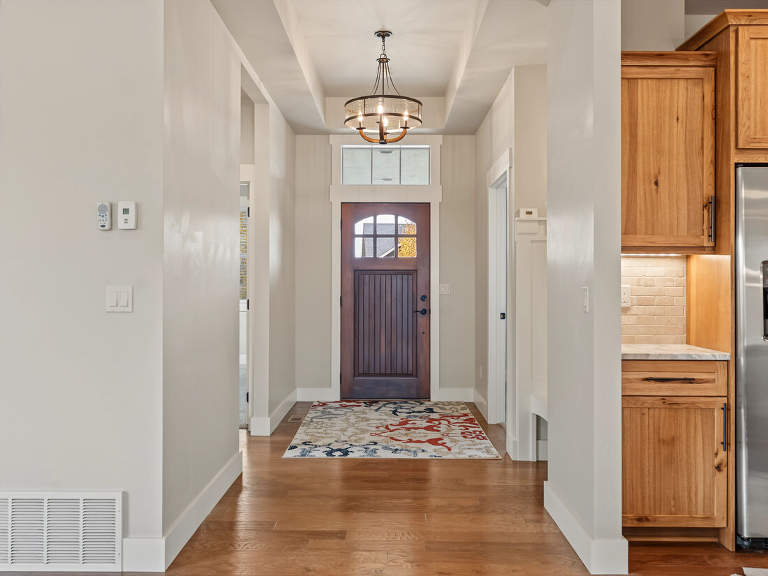 Entry foyer with hardwood floors and front door