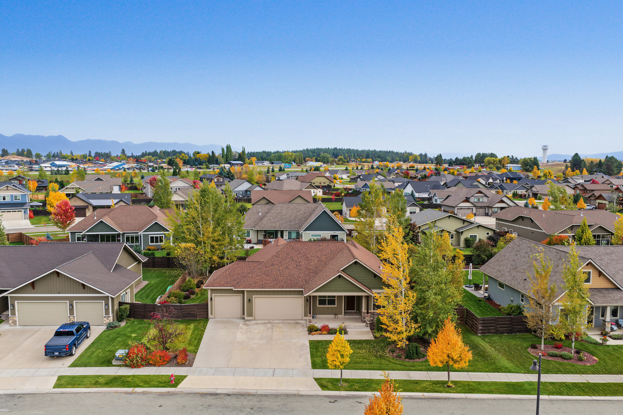 Aerial view of 134 E Swift Creek Way in Silverbrook Estates, Kalispell, with the mountains beyond