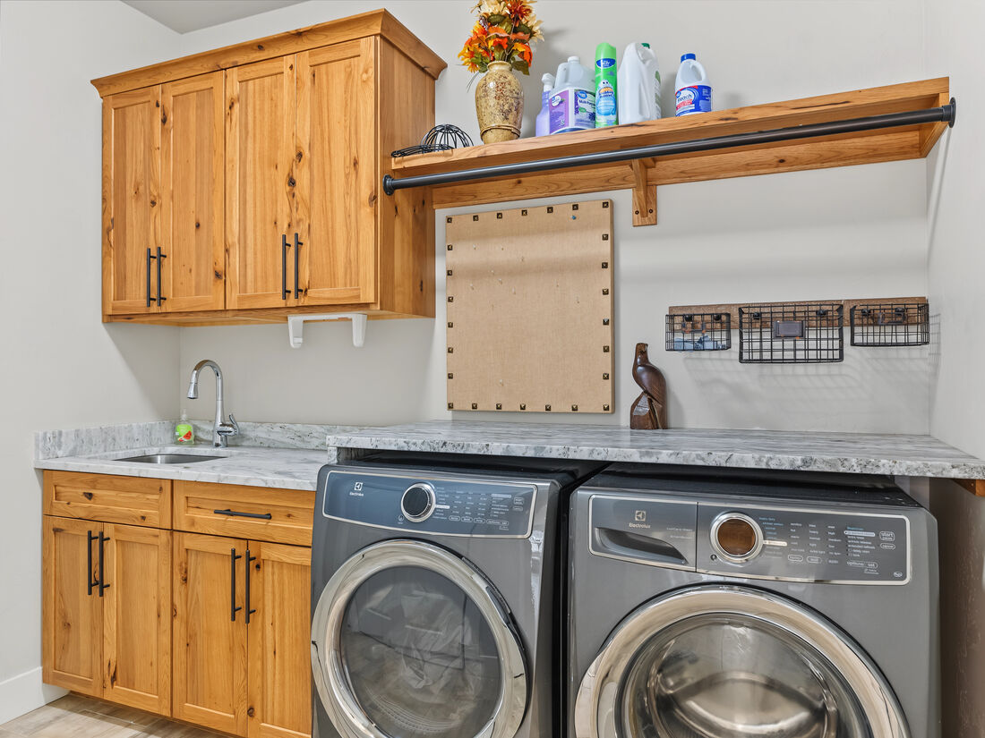 Laundry room with cabinetry and utility sink