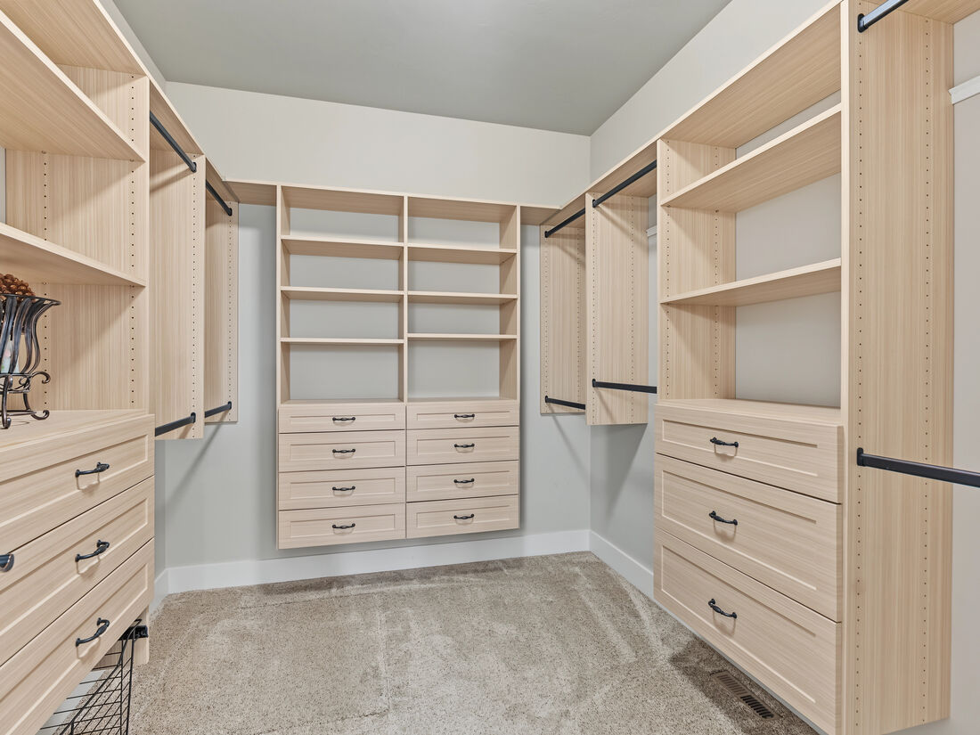 Walk-in closet with built-in shelving and drawers