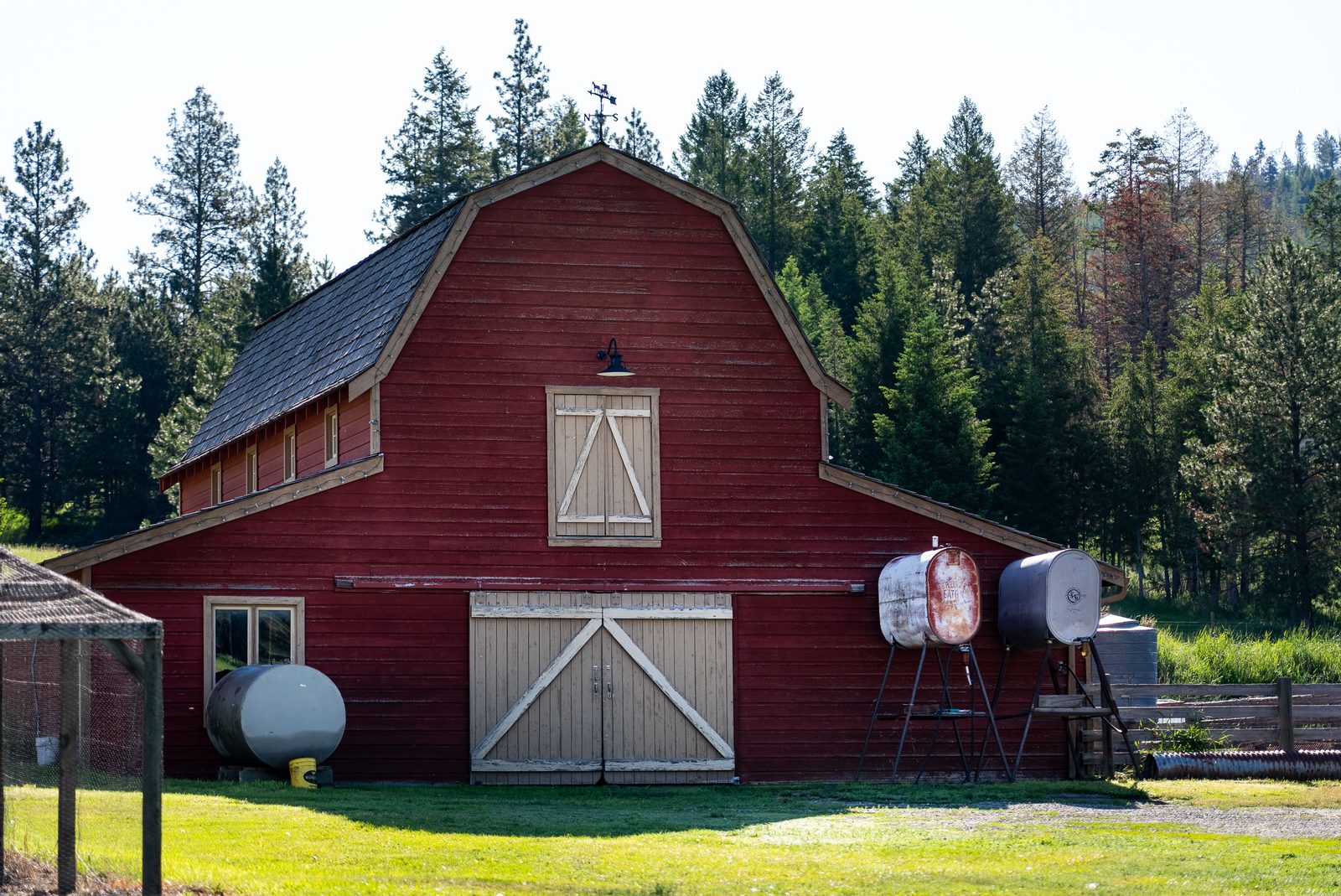 Classic red Montana barn with white trim on the property