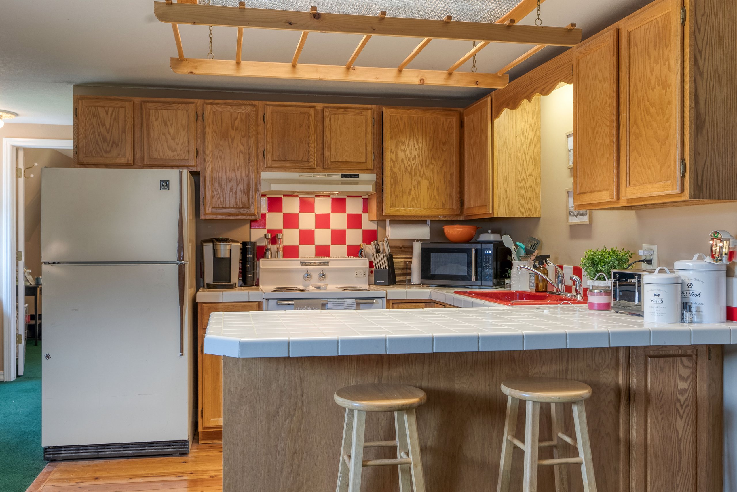 Guest apartment kitchen with oak cabinetry