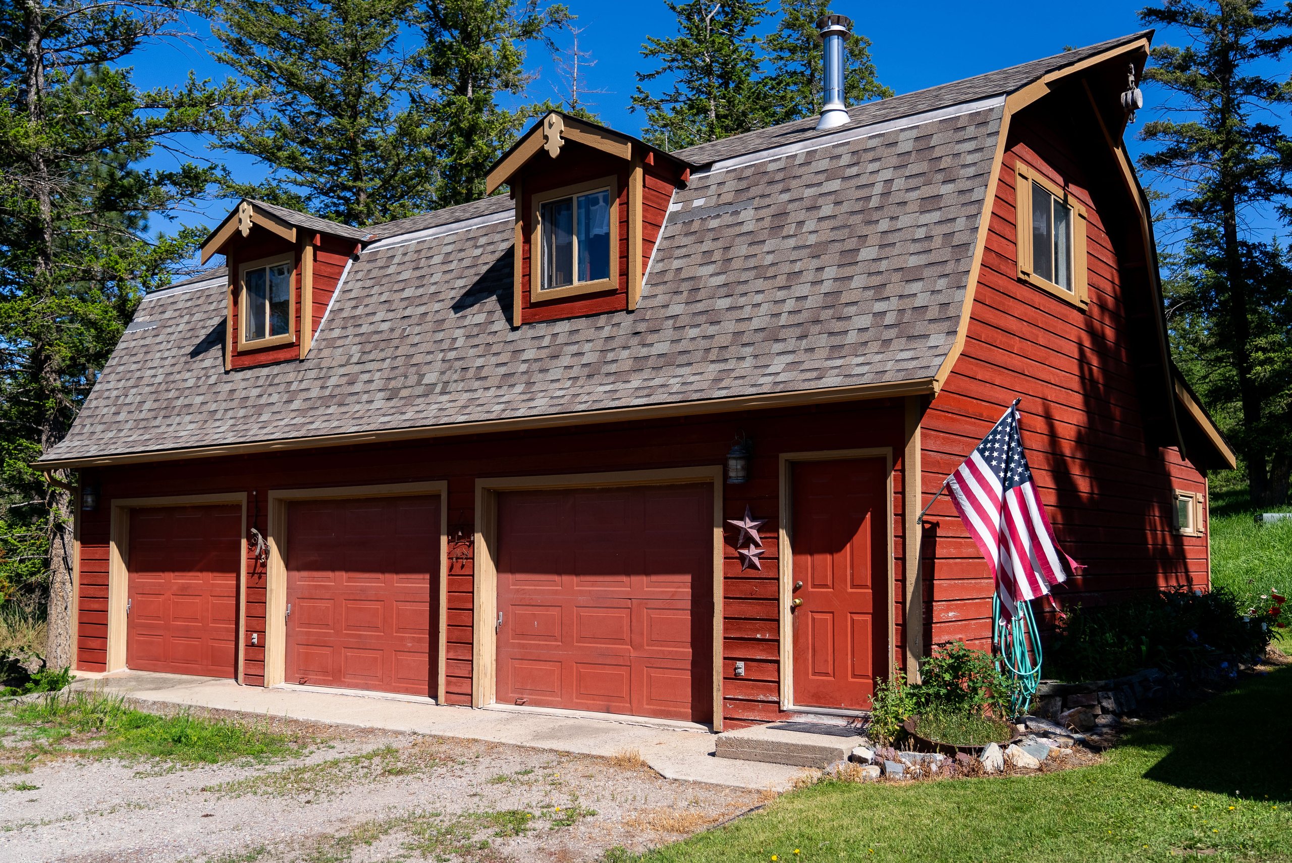 Three-bay detached garage with gambrel roof and guest apartment above